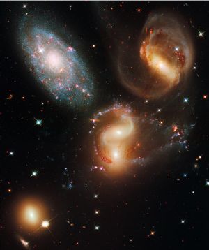 This undated handout image provided by NASA, released Wednesday, Sept. 9, 2009, taken by the refurbished Hubble Space Telescope, shows a clash among members of a famous galaxy quintet revealing an assortment of stars across a wide color range, from young, blue stars to aging, red stars.[Xinhua/AFP] 