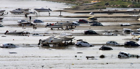 Partially submerged cars are seen next to boats after heavy rains flooded Silivri, a town some 70 km (44 miles) from Istanbul September 8, 2009. 