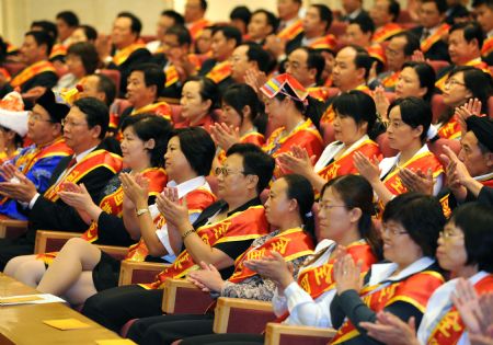 Representatives attend a meeting to honor outstanding teachers in Beijing, capital of China, Sept. 9, 2009, on the eve of China's 25th Teachers' Day.(