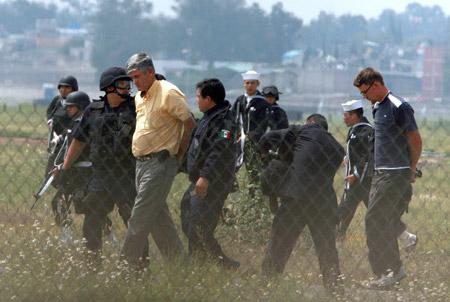 Mexican security forces take into custody a man suspected of being one of the kidnappers of an Aeromexico flight at Mexico City's airport. [Xinhua/AFP] 