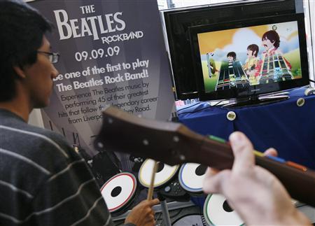 People play 'The Beatles: Rock Band' game during its launch in New York, September 9, 2009.