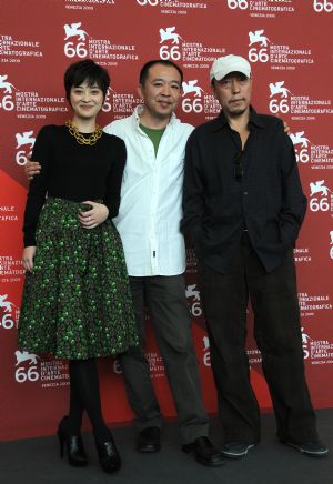 Chinese director Liu Jie(C), actor Ni Dahong(R), and actress Mei Ting are pictured during the presentation of their film 'Touxi (Judge)' during the 66th Venice International Film Festival at Venice Lido, on September 9, 2009. 