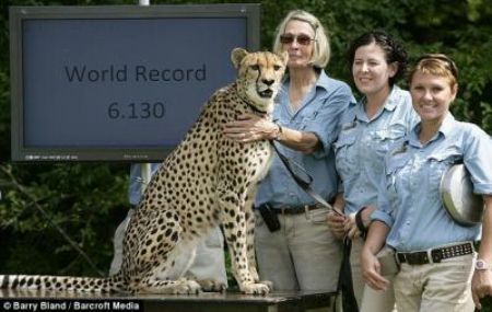 Usain who? The proud eight-year-old poses with keepers at the zoo.