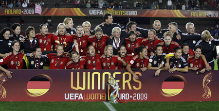 Germany's national soccer team players celebrate with the trophy after winning their UEFA women's Euro 2009 final soccer match against England in Helsinki September 10, 2009.(Xinhua/Reuters Photo)