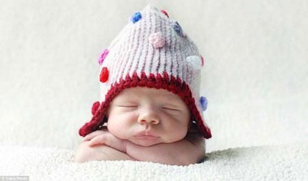 Tracey Raver captures a newborn's expression as it dozes in a spotted woolly hat