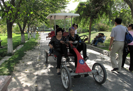 Two women of Uygur ethnic group enjoy the flowers at an arboretum in Urumqi, northwest China's Xinjiang Uygur Autonomous Region, on Saturday, Sept. 12, 2009. [Shen Qiao/Xinhua]