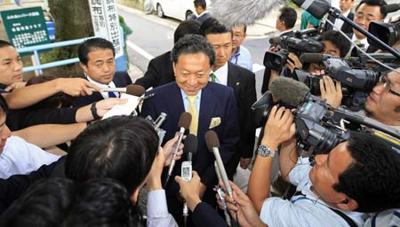 Japan's main opposition Democratic Party leader Yukio Hatoyama answers reporters' questions after casting his absentee ballot for the upcoming house election in Tokyo August 26, 2009.