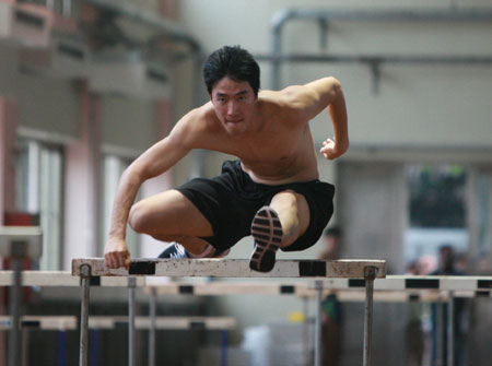 Liu Xiang, China's 110m-hurdle world champion and Olympic gold medal winner clears a hurdle during a training session in Shanghai, east China, on June 30, 2009. As Sun Haiping, Liu's coach said during today's press conference, the hurdler is recovering well from his ankle injury but he is not a hundred percent fit for competition. The former 110m hurdles record holder pulled out of the Beijing Olympics last year due to an injury and has not been in competition since then. (Xinhua/Ren Long) 