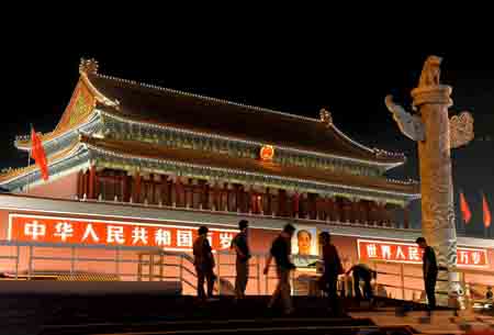 People are seen in front of the illuminated Tian'anmen Gate Tower in Beijing, capital of China, Sept. 14, 2009. A total of 21 lighting installations in the city have been fixed or renovated for the celebration of the 60th anniversary of the founding of the People's Republic of China, which falls on Oct. 1. (Xinhua/ 