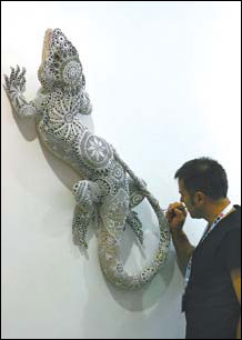 A foreign artist works at the Shanghai Exhibition Center to complete his exhibit for the third ShContemporary.