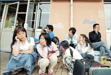 Young migrant women wait for job opportunities outside a job agency. To help young, low-income migrant women in Hangzhou, a pilot education program has been launched to help them integrate with the larger society. 
