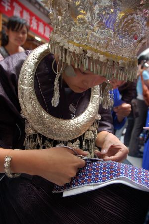A competitor makes embroidery during a traditional handicraft competition in Kaili, southwest China's Guizhou Province, Sept. 15, 2009.