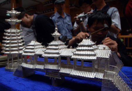 A competitor makes a silver sculpture during a traditional handicraft competition in Kaili, southwest China's Guizhou Province, Sept. 15, 2009.(Xinhua/Wu Ruxiong)