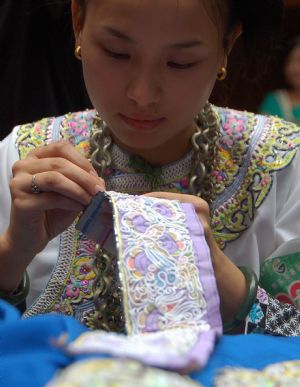 A competitor makes embroidery during a traditional handicraft competition in Kaili, southwest China's Guizhou Province, Sept. 15, 2009.(
