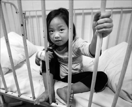 Li Jiangyue, a four-year-old girl in Shangwu village, Dongyang, receives treatment after playing near chemical waste at a garbage collection center. 