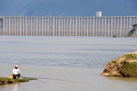 A local goes fishing near the Three Gorges reservoir in Yichang, a city of central China's Hubei Province, Sept. 15, 2009.(