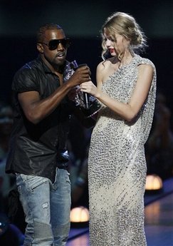 Singer Kanye West takes the microphone from singer Taylor Swift as she accepts the &apos;Best Female Video&apos; award during the MTV Video Music Awards on Sunday, Sept. 13, 2009 in New York.