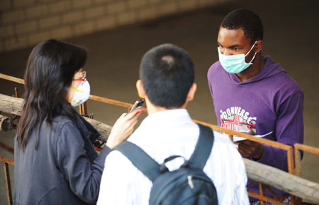 An overseas student is interviewed at Heilongjiang University in Harbin, capital of northeast China's Heilongjiang Province, Sept. 16, 2009. Heilongjiang University scheduled to suspend class from 8:00 a.m. on Sept. 16 to Sept. 19 due to the A/H1N1 flu collective outbreak which was confirmed on Sept. 13.