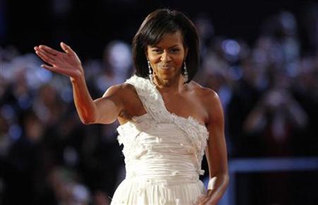 U.S. first lady Michelle Obama waves to the crowd after dancing her first dance of inauguration night with President Barack Obama at the leadoff Neighborhood Inaugural Ball in Washington, January 20, 2009.