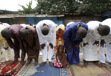 Muslims attend prayers marking the end of Ramadan at a small mosque in Adjame, Abidjan September 20, 2009.