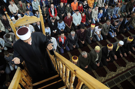 A Bosnian Muslim priest leads early morning prayers on the first day of Eid al-Fitr in the village of Zeljezno Polje, 90 km (56 miles) from the capital Sarajevo, September 20, 2009.