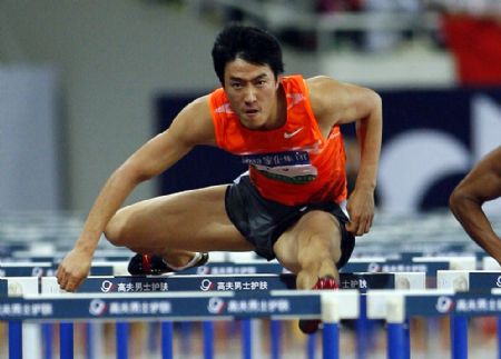 China's 110m-hurdle star Liu Xiang competes during the 110m-hurdle match at the 2009 Shanghai Golden Grand Prix in Shanghai, China, on Sept. 20, 2009. (Xinhua/Fan Jun)