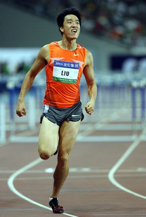 China's 110m-hurdle star Liu Xiang reacts after crossing the finishing line during the 110m-hurdle competition at the 2009 Shanghai Golden Grand Prix in Shanghai, China, on Sep. 20, 2009.(Xinhua/Fan Jun)