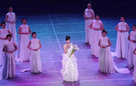 Song Zuying (C), a well-known singer of Chinese folk songs, sings a song of the musical "Road to Revival" at the Great Hall of the People in Beijing, capital of China, on Sept. 20, 2009. The grand musical made its debut here on Sunday night to mark the 60th anniversary of the founding of the People