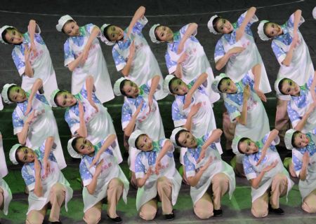 Actresses perform a dance of the musical "Road to Revival" at the Great Hall of the People in Beijing, capital of China, on Sept. 20, 2009.(Xinhua/Chen Shugen)