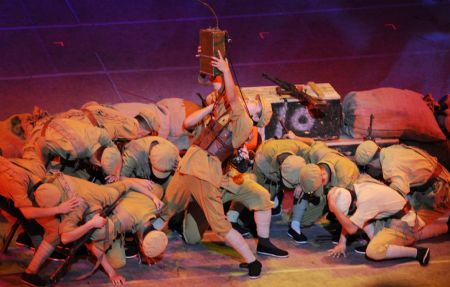 Actors perform a dance of the musical "Road to Revival" at the Great Hall of the People in Beijing, capital of China, on Sept. 20, 2009.(Xinhua/Chen Shugen)