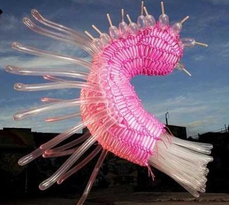 This pink sculpture made of balloons looks like it is about to float up.