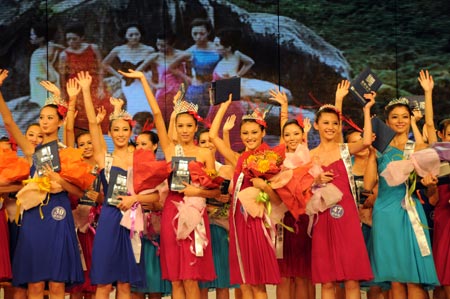 Contestants wave their hands during the final of the 17th New Silk Road Model Contest in Sanya, south China's Hainan Province, September 20, 2009. Zhong Yangyang won the title of the contest attended by some 50 models on Sunday.
