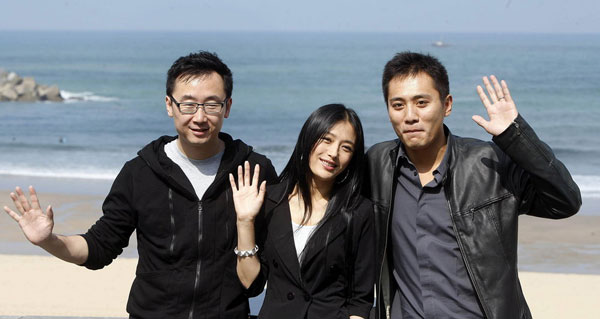Chinese director Lu Chuan (I) poses with cast members Qin Lan (M) and Liu Ye as they promote the film 'City of Life and Death' at the San Sebastian Film Festival in San Sebastian, Spain on September 21, 2009.