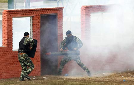 Regimental police of the Hubei Provincial Armed Police Corps take part in the 2009 Comprehensive Counterterror Manoeuvre, jointly launched by the Hubei Provincial Armed Police Corps, the Wuhan Municipal Public Security Bureau, and Wuhan Municipal Bureau of Health, etc, at a drilling base in Wuhan, central China's Hubei Province, Sept 22, 2009. (Xinhua Photo)