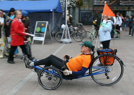 A man rides on a recumbent bicycle as part of an act to celebrate World Car Free Day in Helsinki, capital of Finland, Sept. 22, 2009. (Xinhua/Zhao Changchun)