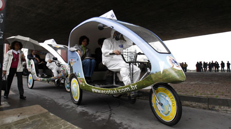 People ride a bike taxi during a protest against cars during World Car Free Day on a road in Sao Paulo September 22, 2009.