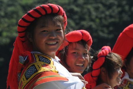 Full-dressed women of the Miao ethnic group attend the opening ceremony of a leek flower cultural festival held in Hezhang, southwest China's Guizhou Province, Sept. 22, 2009. The festival opened on Tuesday in Hezhang county that grows wild leek plants of more than 30 square kilometers. (Xinhua) 