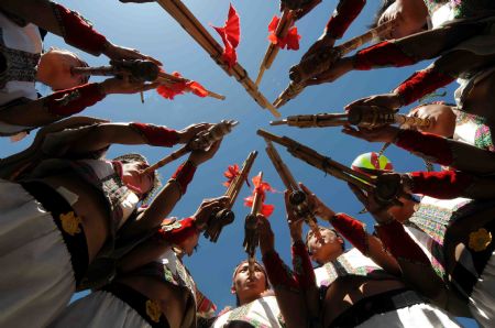 Full-dressed men of the Miao ethnic group dance at the opening ceremony of a leek flower cultural festival held in Hezhang, southwest China's Guizhou Province, Sept. 22, 2009. The festival opened on Tuesday in Hezhang county that grows wild leek plants of more than 30 square kilometers.(Xinhua)