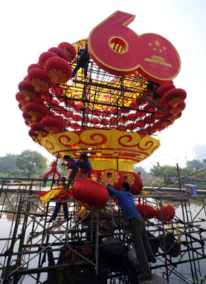 Workers install lanterns at a park in Lanzhou, capital of northwest China's Gansu Province, Sept. 22, 2009. Parks and other scenic sites of the city are decorated to celebrate the 60th anniversary of the founding of the People's Republic of China which falls on Oct. 1.(Xinhua/Han Chuanhao) 