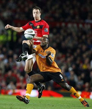 Manchester United's Jonny Evans (top) challenges Wolverhampton Wanderers' Sylvan Ebanks-Blake (bottom) during their English League Cup soccer match at Old Trafford in Manchester, northern England, September 23, 2009.