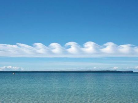 Kelvin-Helmholtz wave clouds live up to their name in this picture from Jervis Bay, Australia. The breaking waveforms of are the result of shearing winds up at cloud level. [Source: CCTV.com] 