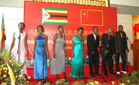 Students from the Confucius Institute of the University of Zimbabwe sing a Chinese song during a reception held by the Chinese Embassy to mark the 60th anniversary of the founding of the People's Republic of China, in Harare, Sept. 24, 2009. (Xinhua/Li Ping)