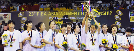 China's Miao Lijie(R4) and her teammate Guan Xin(R5) hold up the trophy during the awarding ceremony after the final match between China and South Korea at the 23rd Asian Women's Basketball Championships in Chennai, India, on Sept. 24, 2009. China beat South Korea 91-71.