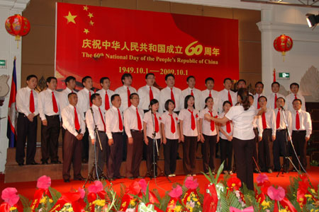 Members of a local Chinese merchants association sing a song in an evening to celebrate the 60th anniversary of founding of the People's Republic of China in Phnom Penh, capital of Cambodia, Sept. 25, 2009. (Xinhua/Lei Baisong)