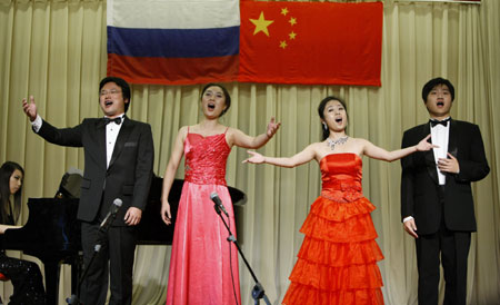 Chinese students sing a song in a evening sponsored by Confucius Institute of Moscow University to celebrate the 60th anniversary of founding of the People's Republic of China in Moscow, capital of Russia, Sept. 25, 2009. (Xinhua/Lu Jinbo)