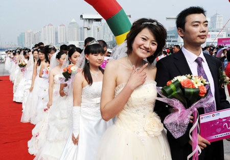 A bride smiles during a mass wedding in Qingdao, east China