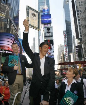The world's tallest man, Sultan Kosen of Turkey, poses for photographers in New York's Times Square, September 21, 2009. The 26-year-old is 2 metres 46.5 cm (8 feet 1 inch) tall, also claiming the record for the largest hands and feet. Kosen is in New York to promote the Guinness book of World Records 2010.