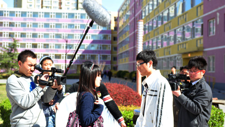 Jia Jia (far left) and his crew shoot his film I Want to Earn Money at Capital University of Economics and Business on April 1.