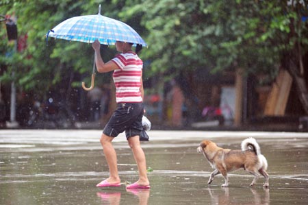  A woman walks on the street with umbrella against strong rainfalls brought by typhoon Kestana, on the street of Qionghai, south China's Hainan Province, Sept. 29, 2009. The typhoon Kestana has affected Qionghai City with continuous gale and brought strong precipitations. Hainan Provincial Meteorologic Bureau has issued orange pre-alert signal against the rainstorm for local administrations to take preventive measures. (Xinhua/Meng Zhongde)