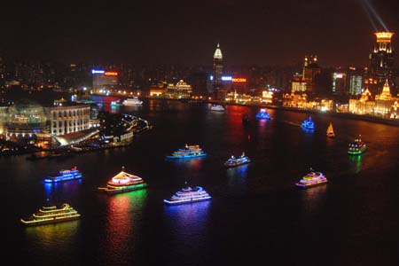 Festooned ships cruise on the Huangpujiang River, during a festival fireworks show together with the festooned ships cruise over the Huangpujiang River to intensify the happy festival atmosphere to usher in the forthcoming 60th anniversary of the founding of the People's Republic of China, in Shanghai, east China, Sept. 28, 2009. (Xinhua/Zhu Lan) 